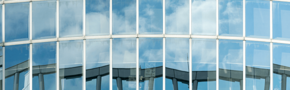 a332478a2bb5-Glass-building-1600x500.png